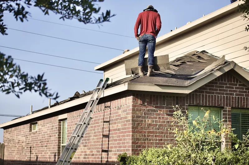 Professional roofer working on a residential roof in Lucama